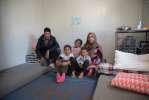 A Syrian family inside their prefabricated container installed by UNHCR at Kara Tepe, in Lesvos, Greece. Over 5,000 refugees and migrants have found shelter in 1,000 prefabricated houses installed by UNHCR across Greece.