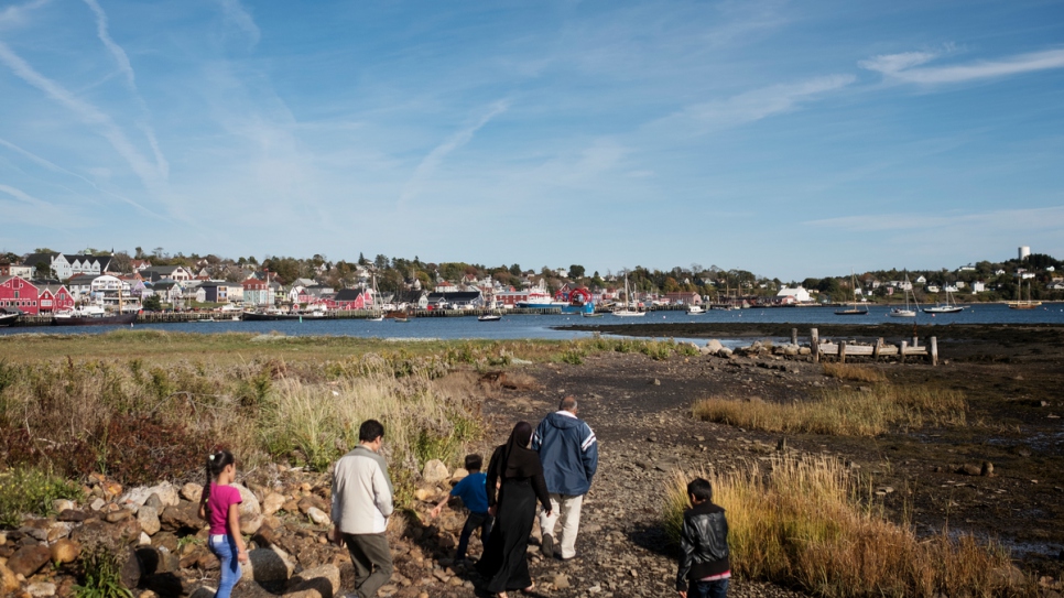 The Ayash family walk along the shore in Lunenburg.