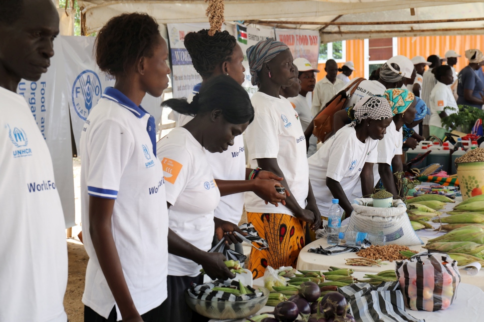 Farmers who are members of UNHCR's livelihoods programme display their crops at a World Food Day event in Juba.