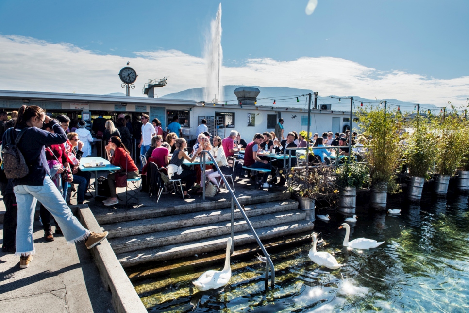 Diners lunch at La Buvette des Bains restaurant on Lake Geneva.