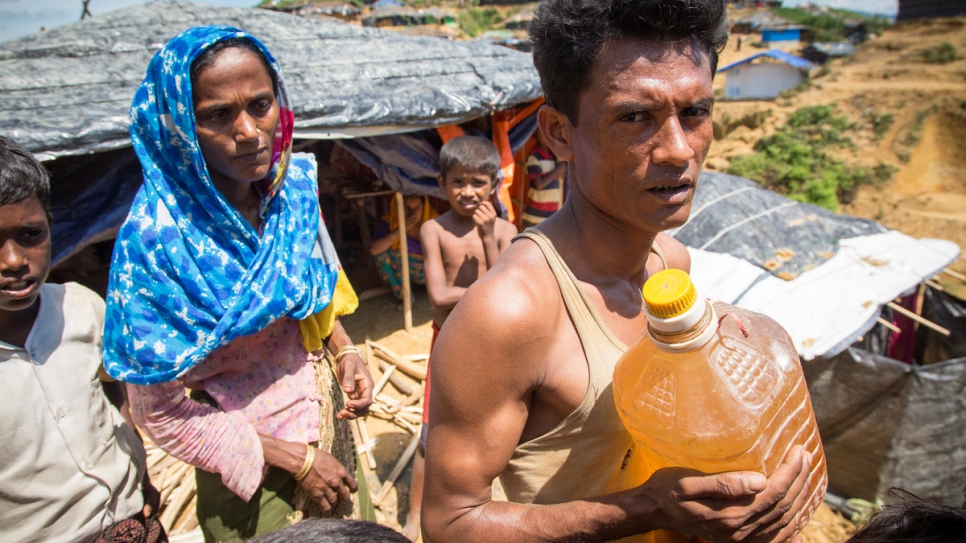 Rohingya refugees Khaleda Begum (left), 25, and Anu Mia, 30, struggle to find clean water in Kutupalong refugee camp extension.