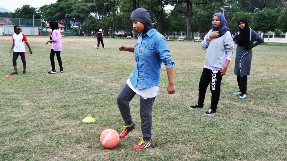 Ekhlas and her team mates undergo dribbling drills during their weekly football practice.