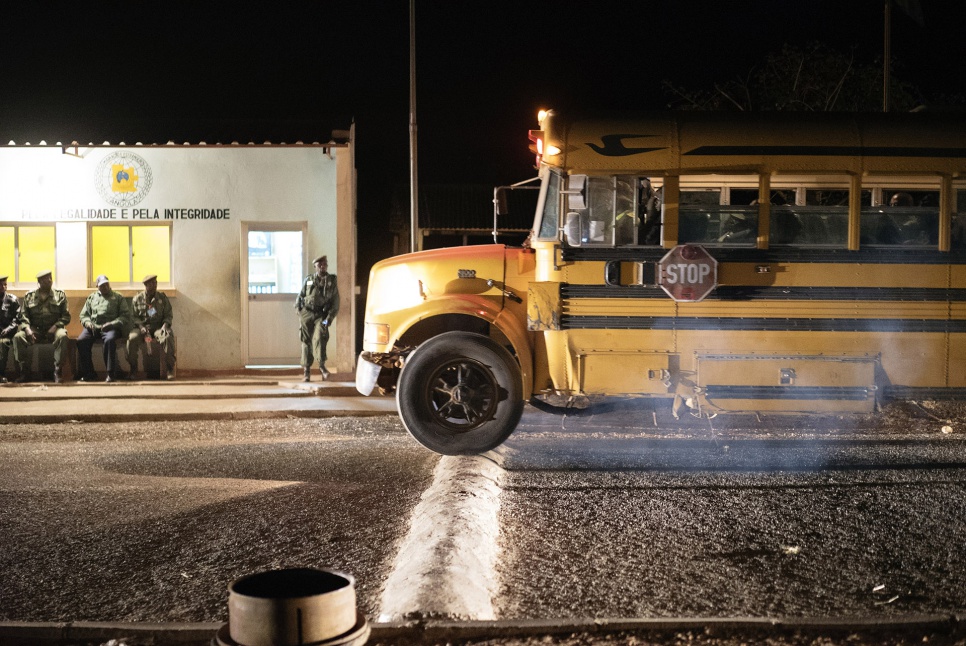 A bus crosses the border into Angola, after officials have checked documents of all the former refugees on board. It has taken them 36 hours to travel through the DRC.