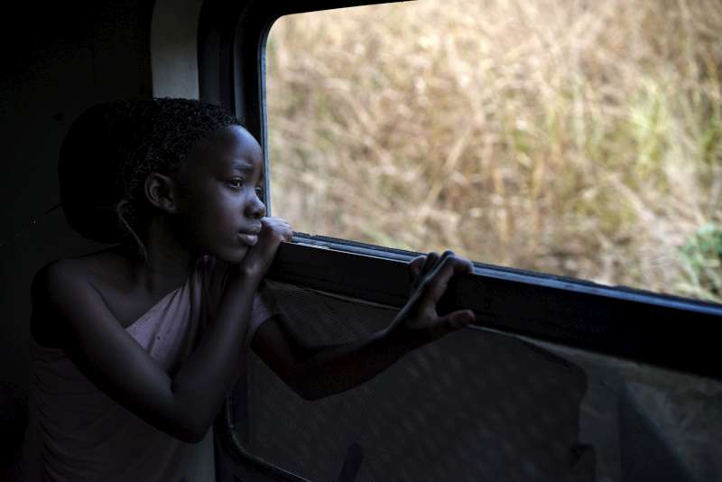 Faria takes in the sights as the train rushes towards Kimpese and she heads towards a new life in Angola, land of her forebears. 