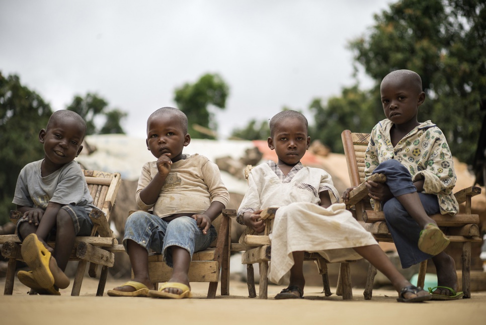 The children of Muslim Central African refugees sit in small wooden chairs at the home of Imam Moussa Bawa while their parents discuss reconciliation in Zongo, DRC.