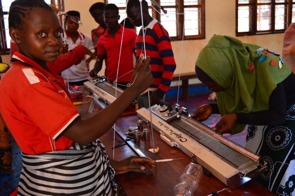 Natalie (left) attends a tailoring class in Mtendeli camp. 