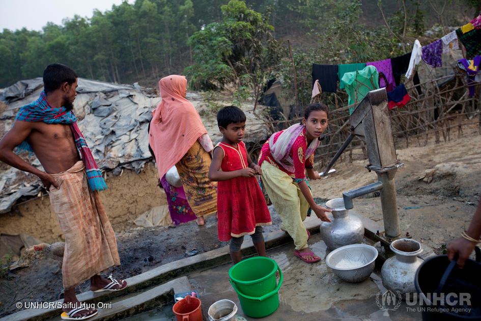 En nyanländ rohingyafamilj fyller hinkar med vatten från en brunn vid en provisorisk bosättning i Cox's Bazar, Bangladesh, där tiotusentals flyktingar har bott sedan en tidigare våldsvåg i Myanmar i oktober 2016. © UNHCR / Saiful Huq Omi