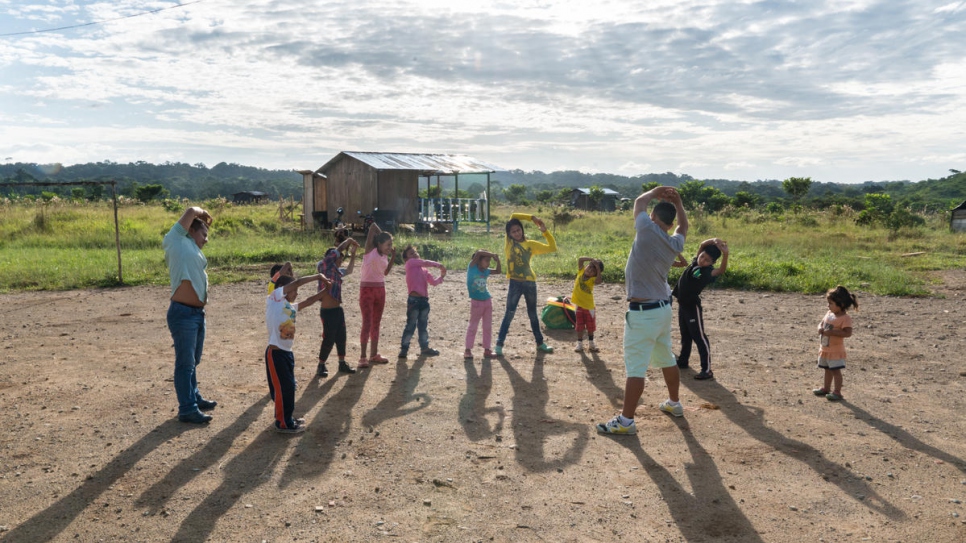 Children play a game during a physical education class. Once a week, a social worker from the municipality comes to the settlement to create special activities for the children.