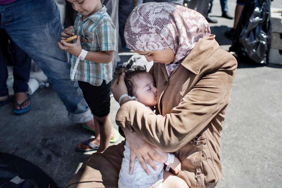 Etaidal, 22, from Damascus, cradles her daughter. Their house in Damascus was destroyed by a bomb three years ago. 
Italy. A total of 218 refugees from Syria, Sudan, Somalia and Eritrea arrived in Catania port on August 26, 2015