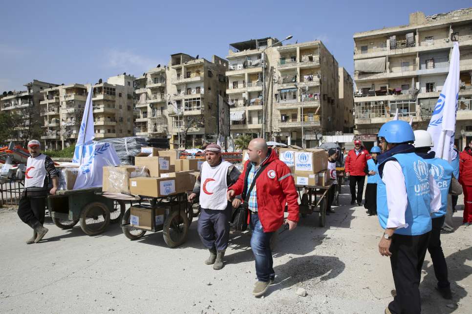 Syria/ IDPs/ UNHCR staff and Syrian Arab Red Crescent (SARC) aid workers are preparing to cross into the eastern neighborhoods of Aleppo carrying the precious aid. A six-hour truce between the Syrian government and anti-government forces enabled UNHCR Syria and SARC to deliver medicine, medical supplies and winter clothing as we'll as food supplies from the World Food Programme to more than 7,000 people in the hard-to-access Bustan Al-Qasr, Al-Ansari, Al-Firdos, Al-Sukari and Mwasalat neighborhoods of Syria's second largest city Aleppo. This cross line mission was carried out for the first time since last October. 45 carts were used to transport the aid from UNHCR trucks at the Bustan Al Qasr crossing point and then pulled across the frontline. It took several trips to complete the operation. Eastern Aleppo has suffered particularly badly since the Syria crisis began in March 2011, but despite the fighting it is still home to an estimated 600,000 people./ UNHCR/B.Diab/ March 2015