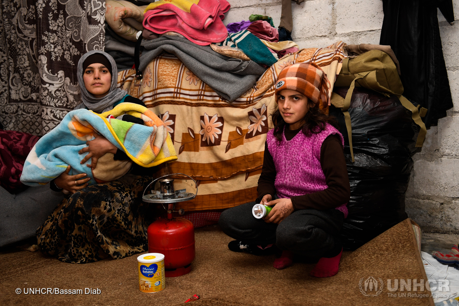 Um Ahmad, a displaced woman from east Aleppo, heats some water to prepare milk for her newly born baby with a help from her daughter. Um Ahmad gave birth a week ago in poor and cold conditions inside her room at Jibreen collective shelter, “I covered the concrete walls with blankets in order to keep some warmth inside the room,” Um Ahmad said. Given the bitter winter conditions, UNHCR and partners are focusing on providing the displaced families in collective shelters with means that bring them some warmth. Over 261,000 people have received aid across Aleppo via the distribution of heaters, blankets, mattresses, winter clothes, insulation kits, family tents, carpets, sleeping bags and jerry cans. Much more is needed to help weather the freezing conditions in the city. ; The brutal fight for Aleppo, which lasted over four years, ended last month when government-backed forces re-established control over the ancient city, and evacuations of citizens were arranged. There are now tentative hopes that the warring sides will engage in peace talks to end the broader civil war. Among the estimated 1.5 million people now in Aleppo, UN agencies have access to about 400,000, the same number that are estimated as displaced in the city. Some families have settled with friends and family. However, many thousands are sheltering in damaged buildings or informal settlements.
UNHCR, other UN agencies and partners have been focusing on immediate assistance. The priorities are shelter, food, fuel, winter clothing, water and sanitation, medical support and civilian protection for a population scarred by years of conflict.