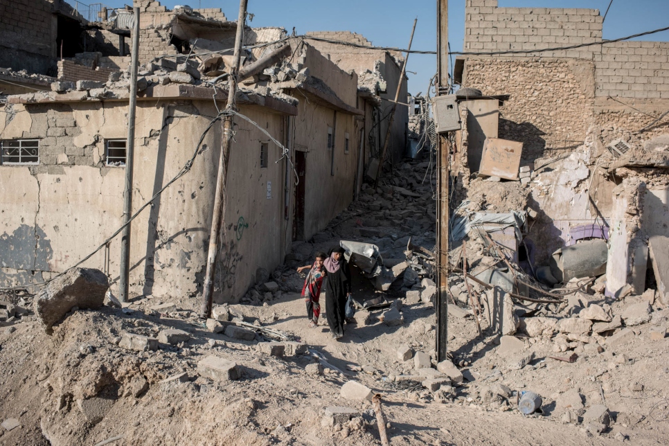 Halan helps her injured daughter Khalida flee Mosul, Iraq on June 25, 2017.