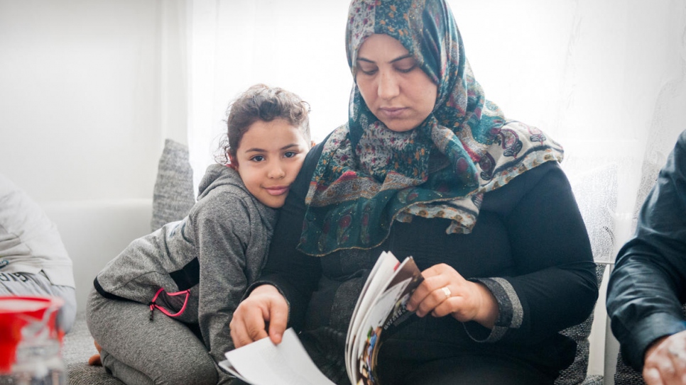 Hayat Elwees and her six-year-old daughter Maryam read a book at home in Vienna, after completing the reunification process.