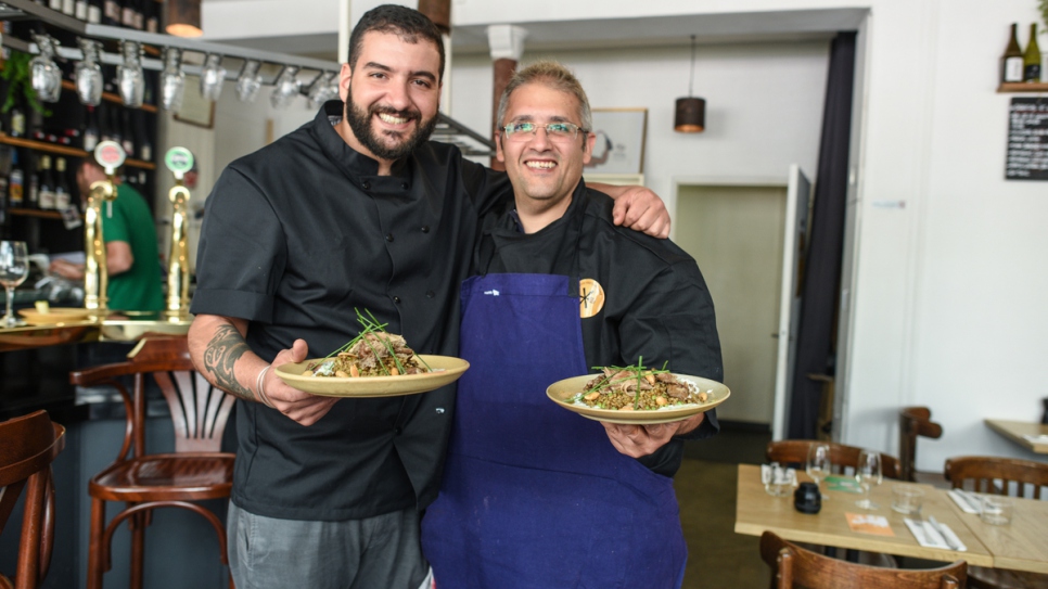 Syrian refugee chef Nabil Attar and French chef Walid Sahed show their joint creation at Les Pantins restaurant in Paris on June 16, 2017.

 