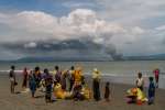 Rohingya families gather on the beach at Dakhinpara, Bangladesh, after crossing the sea on fishing boats from Myanmar.