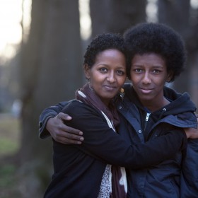 Atlanta, Georgia/Kenya Refugee/Naima Abdullahi, 36, with her son Teso, 14, outside their home in Atlanta, Georgia. Naima's uncle was murdered in Ethiopia for his involvement in the Oromo movement, her parents fled to Kenya as political refugees. Growing up in Kenya, Naima and her three siblings could not tell anyone they were refugees. It became a family secret, and they always had a fear of being caught. When Naima was 10 years old her family was resettled in San Jose, California, with the help of the IRC.Since Naima was initially the only one who spoke English, she became the family spokesperson and took on a lot of responsibilities at a young age. Eventually her family moved to Seattle and they all became U.S. citizens in 1996. Today, Naima has worked as a caseworker at the IRC in Atlanta for five years. ÒI enjoy working with my clients," she said, ÒI see my parents and I see myself in them." Naima plans to focus on women's health and well-being to empower refugee women to have a voice and educate them so they will learn to take care of themselves as their opportunities and responsibilities grow in America. "I think because of being a refugee I understand life in a completely different way. I still remember where we were, where I started, the house I lived. Today on this end I have everything at my fingertips. I have opportunities, especially as woman, that I wouldn't have had.I can make things happen for myself, whether I make it or not is all up to me." "When I lived in Nairobi we would go downtown and  UNHCR /  would give you a voucher for school uniforms and backpacks. We looked forward to that every year. UNHCR registered us and gave us refugee status. My dad worked with UNHCR as a contractor building schools. The times that he worked with UNHCR were the best times because he had a good income."/UNHCR/E.Hockstein/February 2013