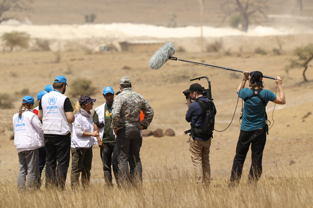 Team Alpha negotiates with military at a check-point in order to be able to access Nigerian refugees who have just arrived in Cameroon, while a UNHCR video crew film them for a documentary movie on the WEM. © UNHCR / Helene Caux