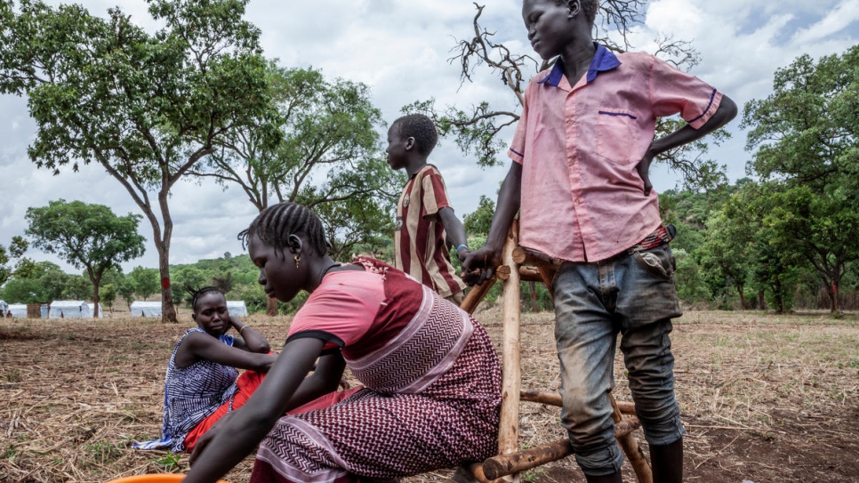 Dinai and his siblings spend the day together in Gure Shombola Camp, Ethiopia.