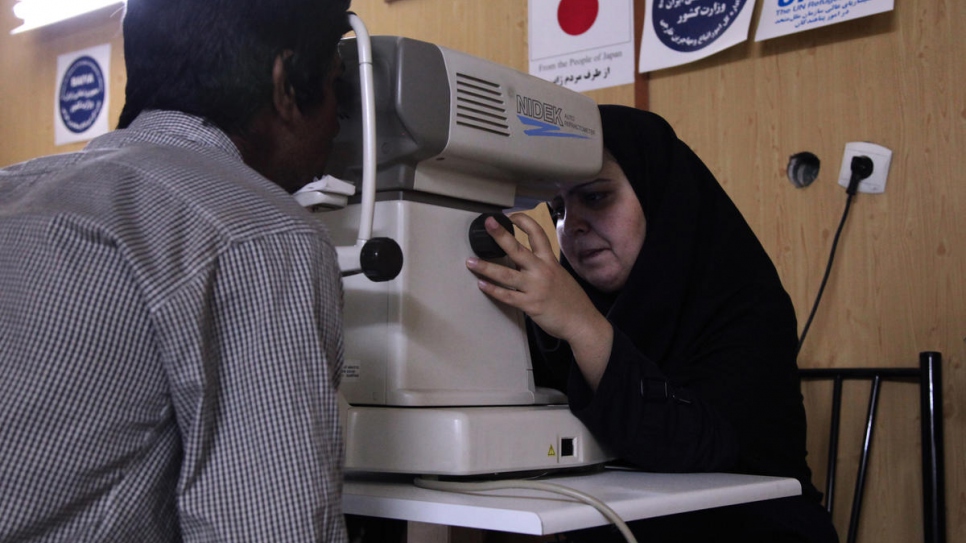 An Afghan refugee undergoes an eye examination at a health centre in Iran. 