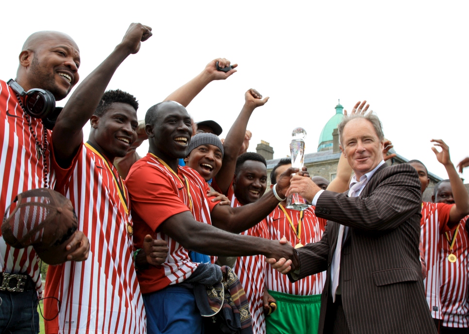 Former Republic of Ireland football manager, Brian Kerr, presenting the winner's trophy to KASI at the Fair Play Football Cup 2013