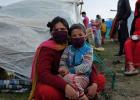 A mother and her child next to their tent in Ratna Park