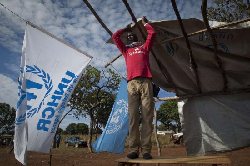 A refugee helps put up a UNHCR tent in the Cameroon. Sub-Saharan Africa remains the largest recipient of UNHCR assistance.