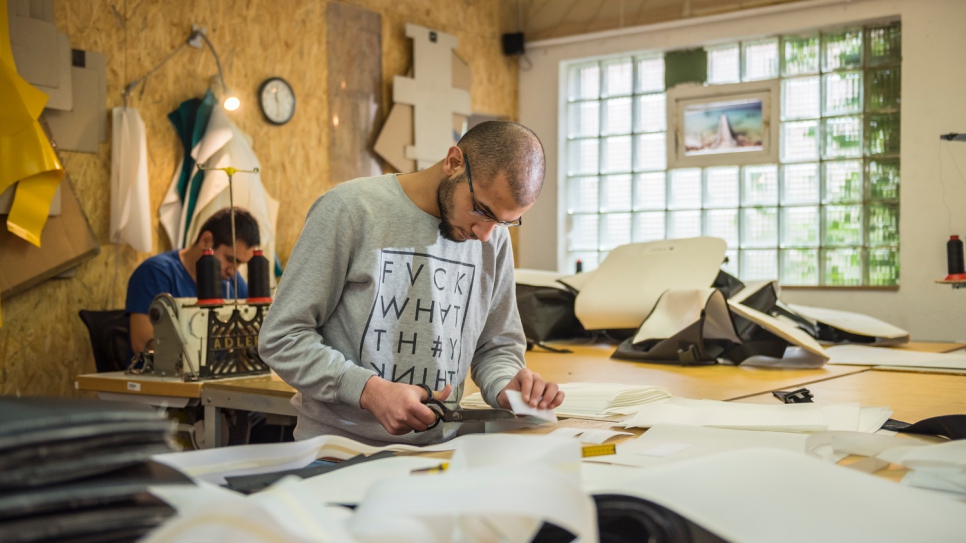 In Damascus, Yousef, 23, used to make curtains with his father. Now refugees in Kiel, Germany, they put their skills to good use at a sail-making company named Coastworxx.