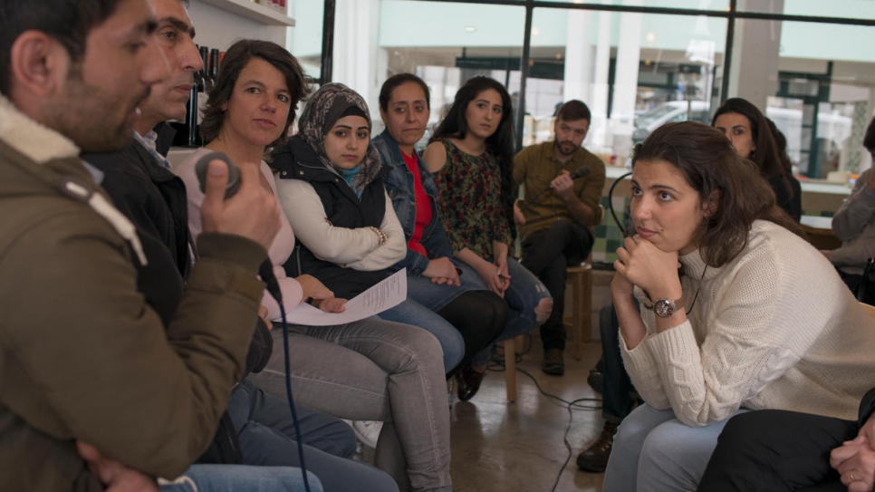 At a discussion evening in Lisbon's Mezze restaurant, Syrian newcomers answer questions from the Portuguese public.