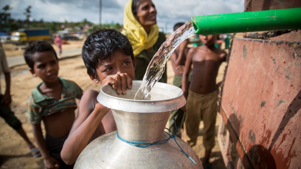 A Rohingya boy fills a water jug from a pipe at Kutupalong refugee camp in Bangladesh on October 6 2017.