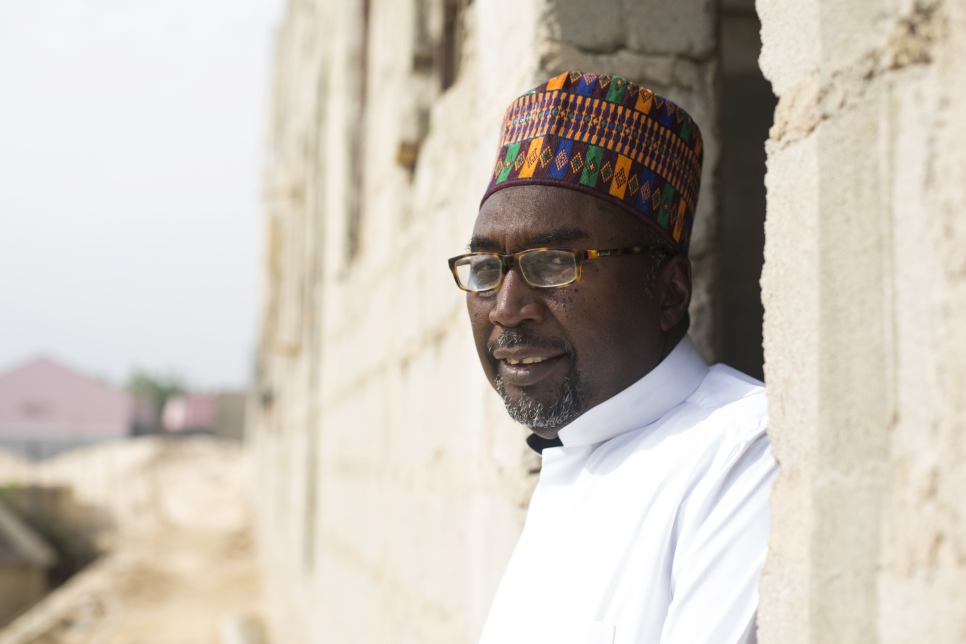 Mr Mustapha stands outside his third school, being built next to the Future Prowess Islamic Foundation School (II) on the banks of the River Gadabul. The school will enroll mature students who have missed out on their education due to the conflict. Hostels will allow girls and boys to stay overnight.