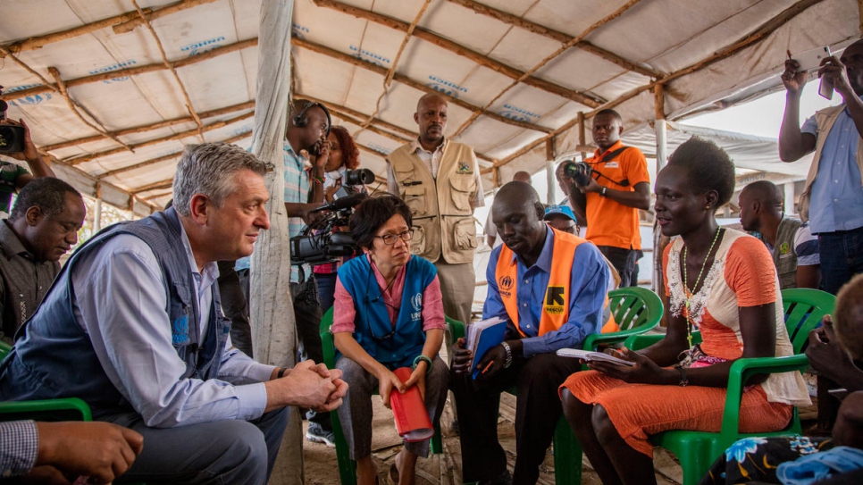 UNHCR head Filippo Grandi talks with refugees at Imvepi refugee settlement during a visit to Uganda to where 500 refugees flee every day.