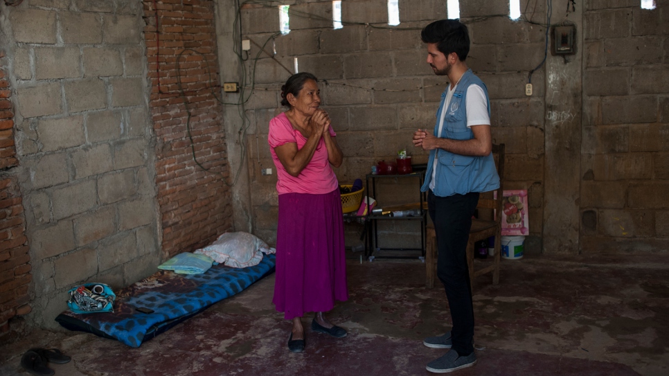 Margarita talks to a UNHCR protection officer in her modest home in southern Mexico.