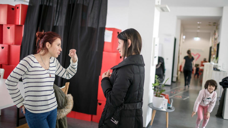 Syrian instructor Rita Butman (left) talks to a student after class at the ReDI school.