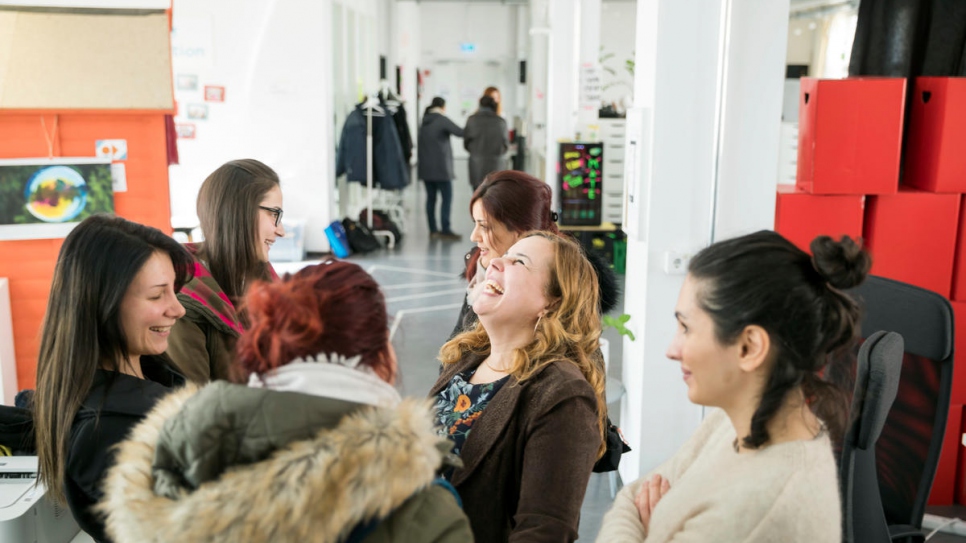 Anan Jakich (centre) talks to fellow students after their class at the ReDI school in Berlin.