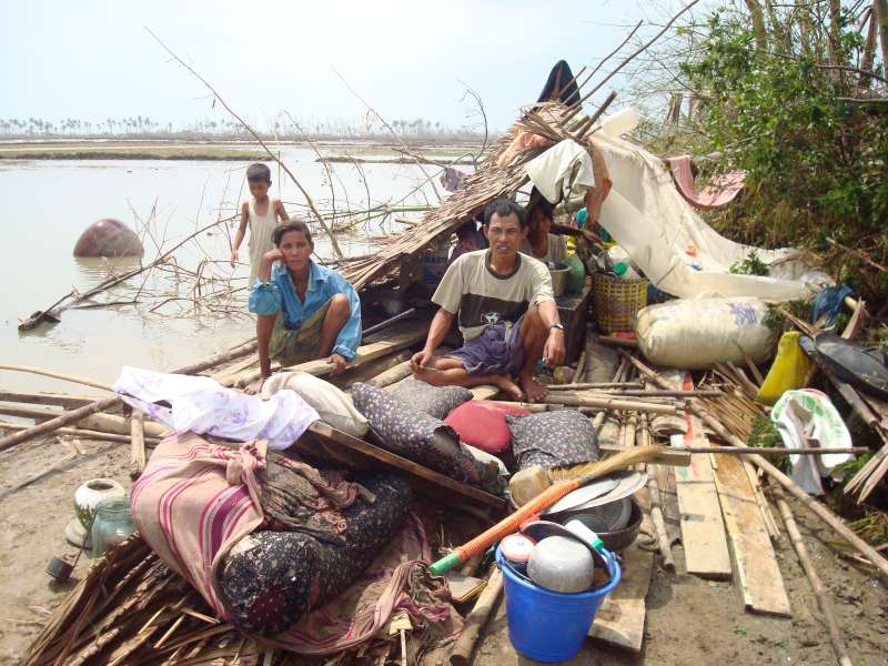 Survivors of 2008’s Cyclone Nargis shelter in the ruins of their destroyed home in War Chaun, a village in Myanmar’s Ayeyarwaddy Division. 