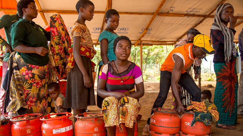 Burundian refugee Frida Nehebauwayo, 17, queues to receive an LPG cylinder.