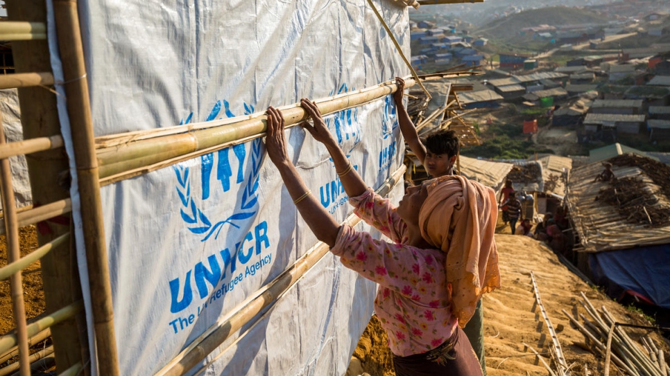 Rohingya refugees reinforce their shelters with materials supplied by UNHCR at the Kutupalong refugee settlement.