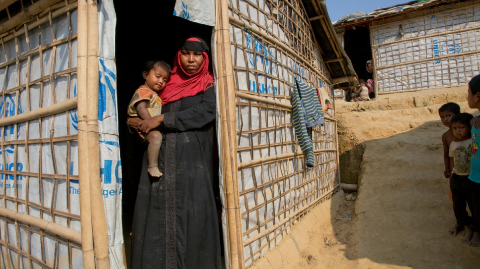 Rohingya refugee Jhura stands outside her shelter in Kutupalong settlement, Bangladesh.