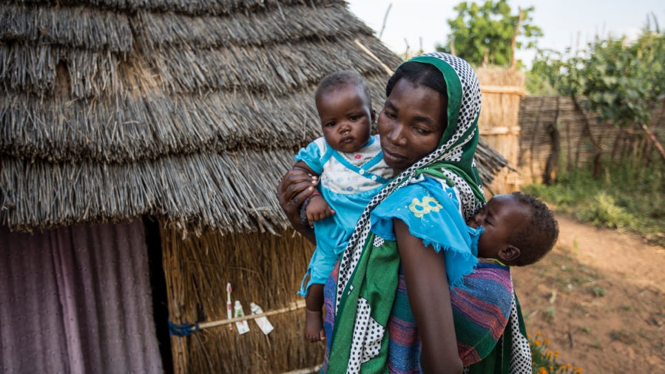 Sudanese refugee Noura Adam with her eight-month-old twin daughters in Djabal camp, Chad. Both babies are being treated for malnutrition.