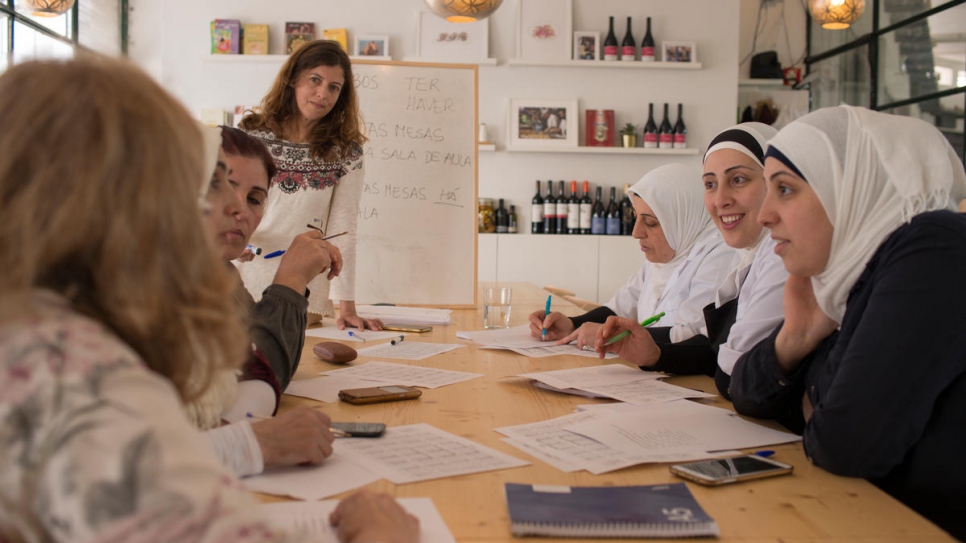 Between shifts, Mezze chefs Fatima and her two daughters, Rana and Reem, from Syria, sit down with other staff to improve their Portuguese. 