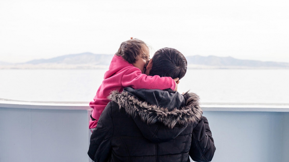 Mohamad Alhajer with his four-year-old daughter Maria on the ferry Nissos Chios taking them from the island of Samos to start a new life in mainland Greece. 