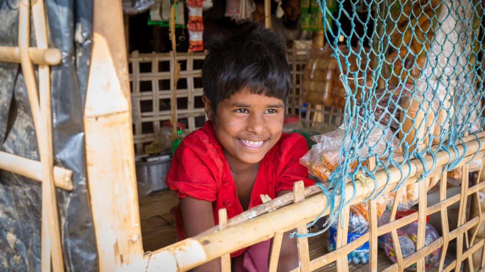 A Rohingya child looks out from a small grocery store in Kutupalong Refugee Settlement.