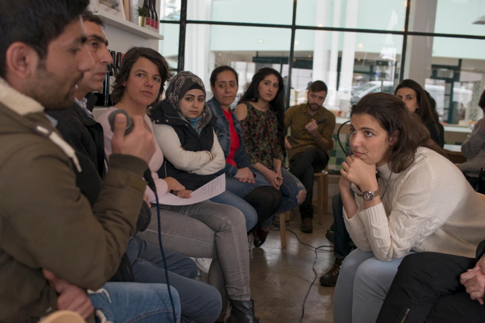 في أمسية نقاش في مطعم مزة في لشبونة، يجيب السوريون الوافدون حديثاً على أسئلة الجمهور البرتغالي.
