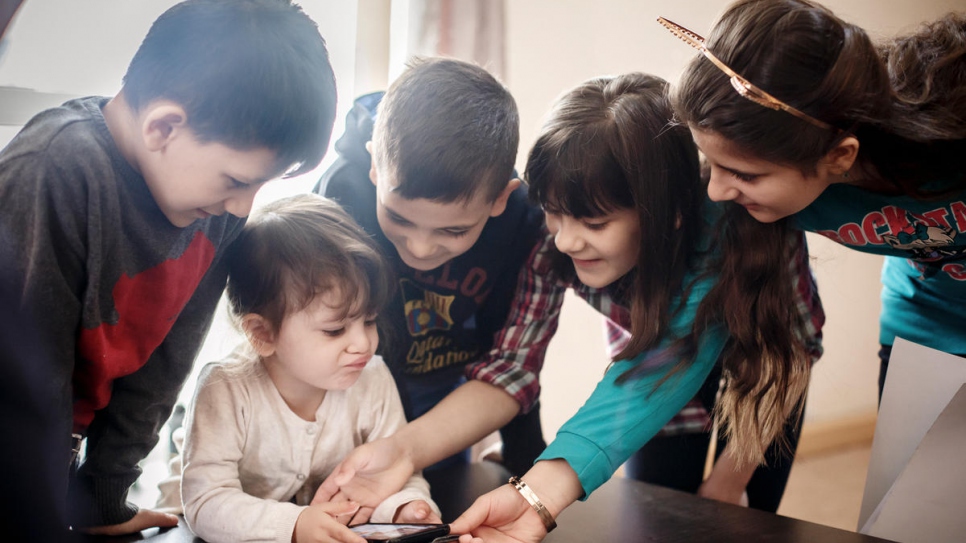 The Ahmad children play together in their new home in Gomel, Belarus.