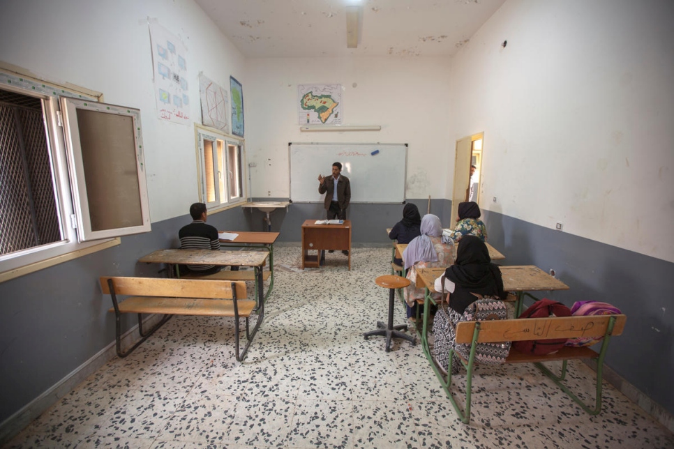 Libya. Mohamed teaching the few returnee children that still attend school in Gwalish