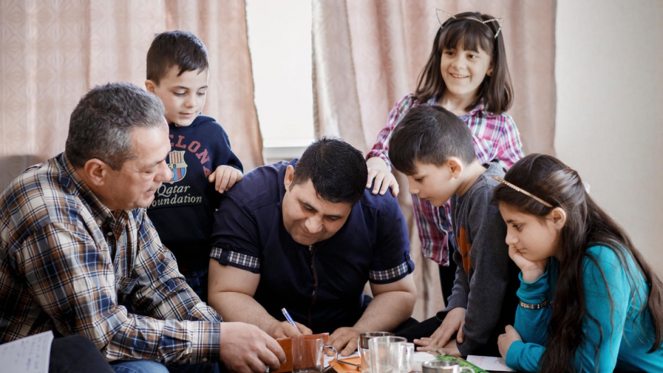 Imad Ahmad with with four of his five children and Tengiz Kolbaya.
