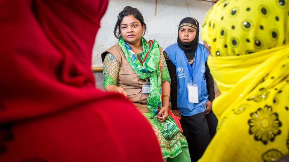 Fatama Islam, a Bangladeshi staffer with Technical Assistance Inc and Community Outreach Member Nur Bahara counsel Shamshidah and Mabia.

