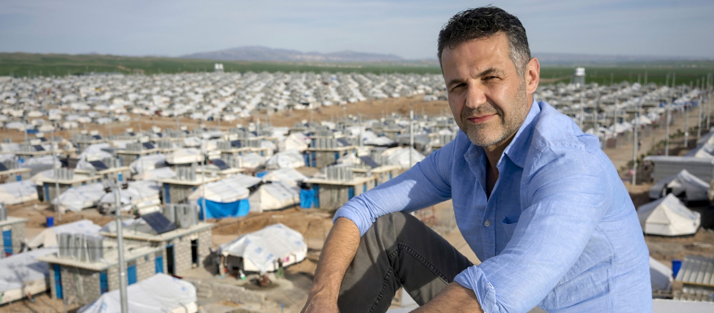 UNHCR Goodwill Ambassador Khaled Hosseini poses for a portrait atop a water tank overlooking Darashakran refugee camp, Iraq 