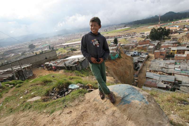 Barrio "Altos de la Florida", shantytown, Bogota. An IDP child stands where one of his friends recently fell down a 50 meters high rock barrier located just next to their houses.