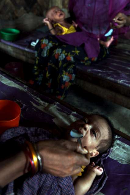 A mother feeds her child milk at the feeding centre in Nayapara camp, Cox's Bazar district.